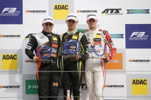 Joey Mawson alongside McLaren F1 Junior Driver Lando Norris and Mick Schumacher on the Rookie podium